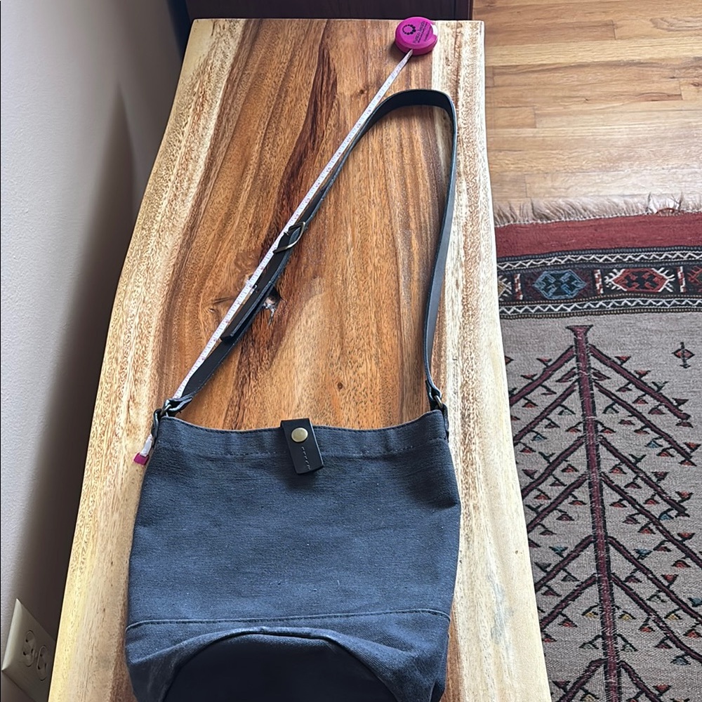 Black Crossbody Bag with Adjustable Strap and Flap Closure